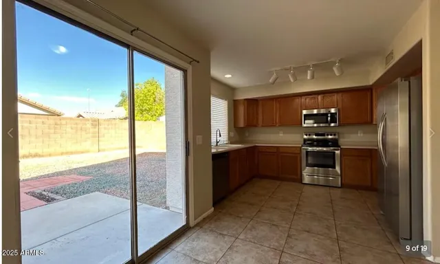 a kitchen with stainless steel appliances granite countertop a refrigerator and a sink