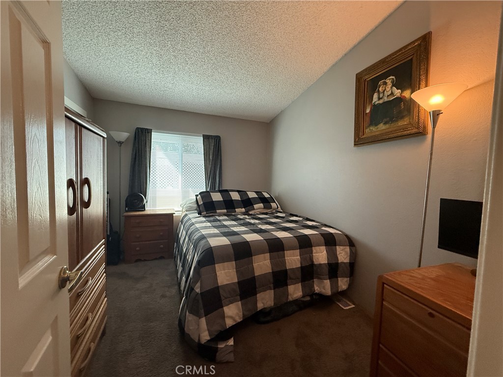 1550 Rory Lane Simi Valley, CA 93063 - Photo 12 of 26 a bedroom with a bed and a flat screen tv