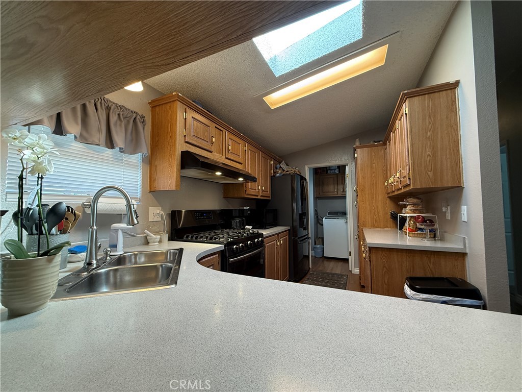 1550 Rory Lane Simi Valley, CA 93063 - Photo 3 of 26 a kitchen with refrigerator a stove and a sink