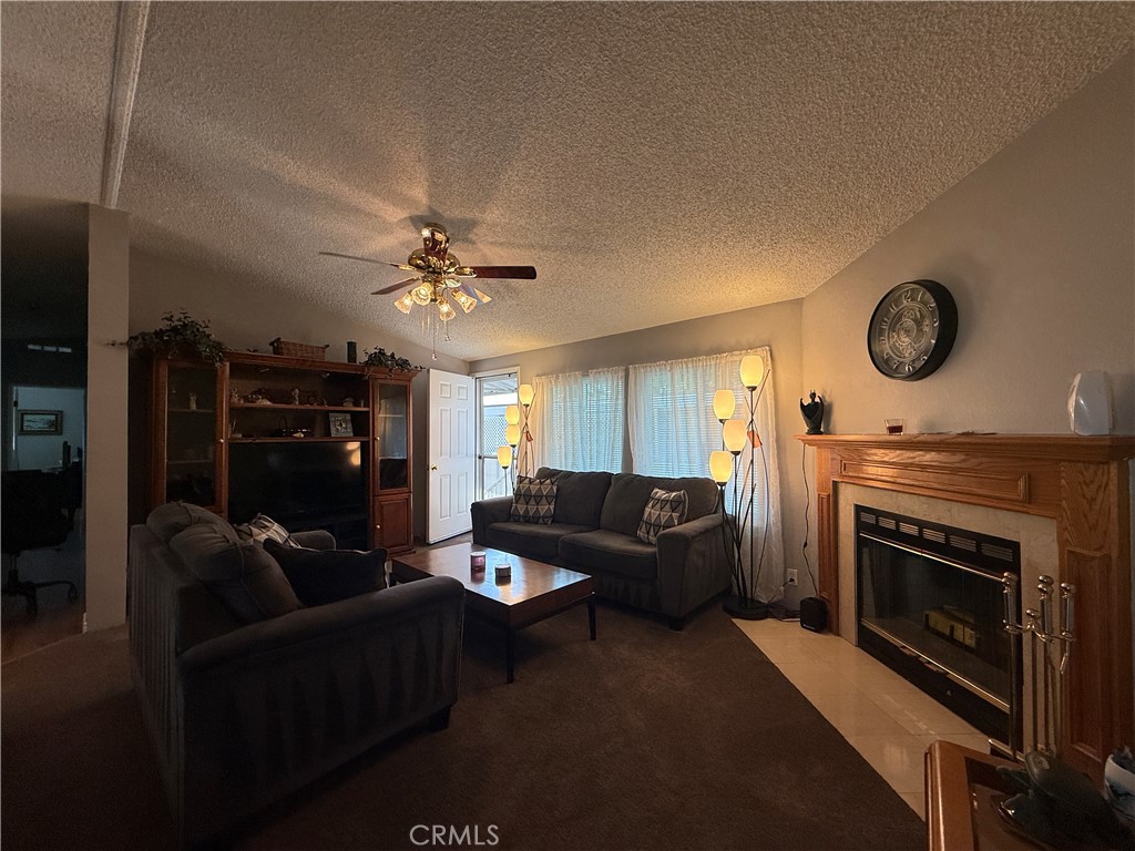 1550 Rory Lane Simi Valley, CA 93063 - Photo 4 of 26 a living room with furniture a clock and a fireplace