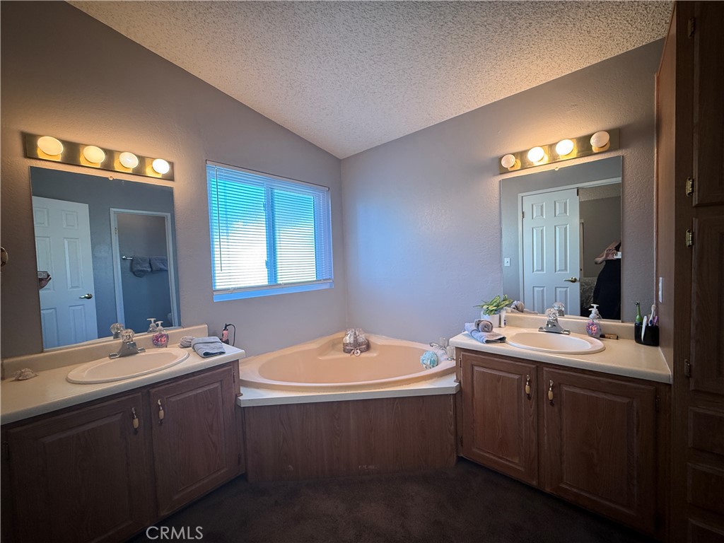 1550 Rory Lane Simi Valley, CA 93063 - Photo 9 of 26 a bathroom with a double vanity sink a mirror and bathtub