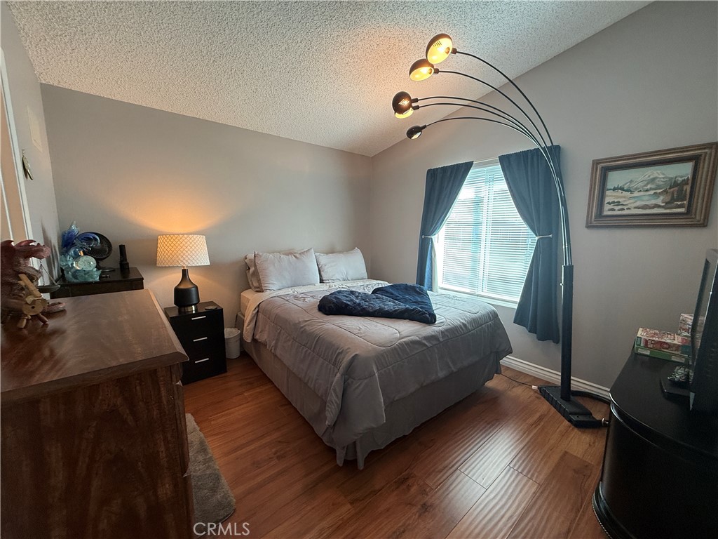 1550 Rory Lane Simi Valley, CA 93063 - Photo 10 of 26 a bedroom with a bed and wooden floor