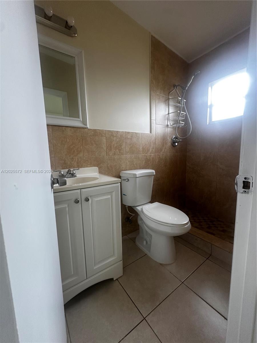 14475 Southwest 288th Street Homestead, FL 33033 - Photo 5 of 26 a bathroom with a toilet a sink and mirror