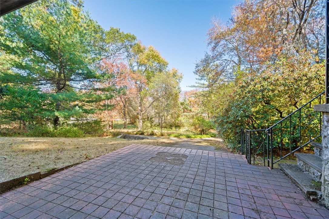 10 Midway Street Scituate, RI 02857 - Photo 21 of 35 rear patio with view of 2nd driveway from the rte 6 side of the property.