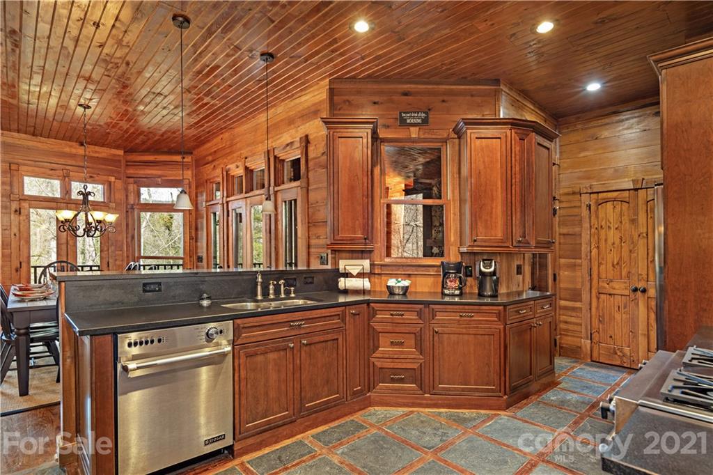 471 Chestnut Hill Loop Road Gerton, NC 28735 - Photo 15 of 45 a kitchen with stainless steel appliances granite countertop a sink and cabinets
