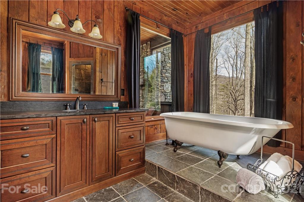 471 Chestnut Hill Loop Road Gerton, NC 28735 - Photo 34 of 45 a bathroom with a sink mirror and a bathtub