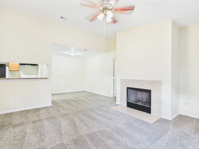 a view of an empty room with a fireplace