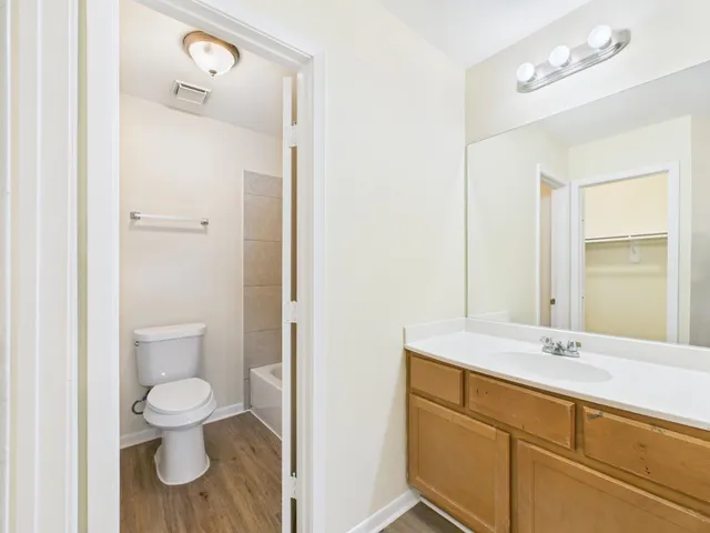 a white bath tub sitting next to a white toilet and a shower