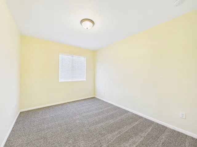 a view of a room with wooden floor and white walls
