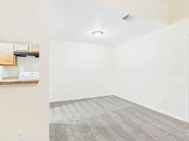 an empty room with windows and entrance