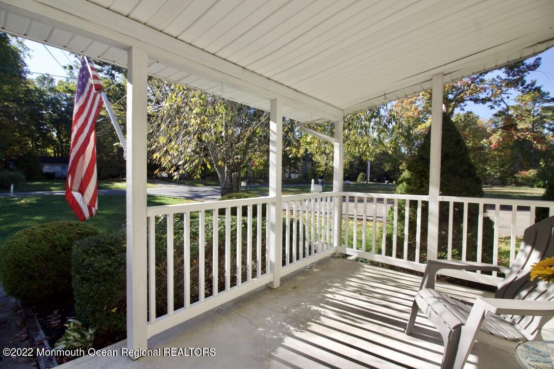 488 Freehold Road Jackson, NJ 08527 - Photo 7 of 19 a view of a balcony with wooden floor and outdoor seating