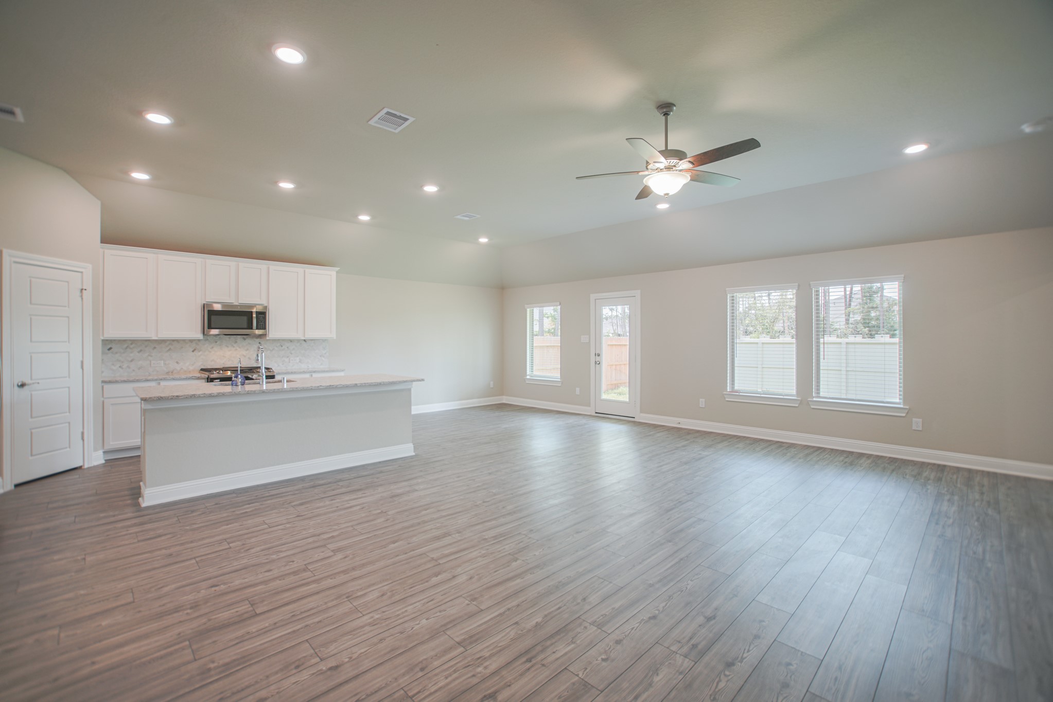 17112 Coneflower Place Conroe, TX 77385 - Photo 5 of 27 a view of an empty room with window and wooden floor