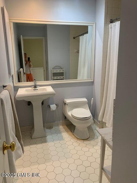 7 River Road, Unit 306 Cos Cob, CT 06807 - Photo 13 of 20 a bathroom with a toilet a sink and a mirror
