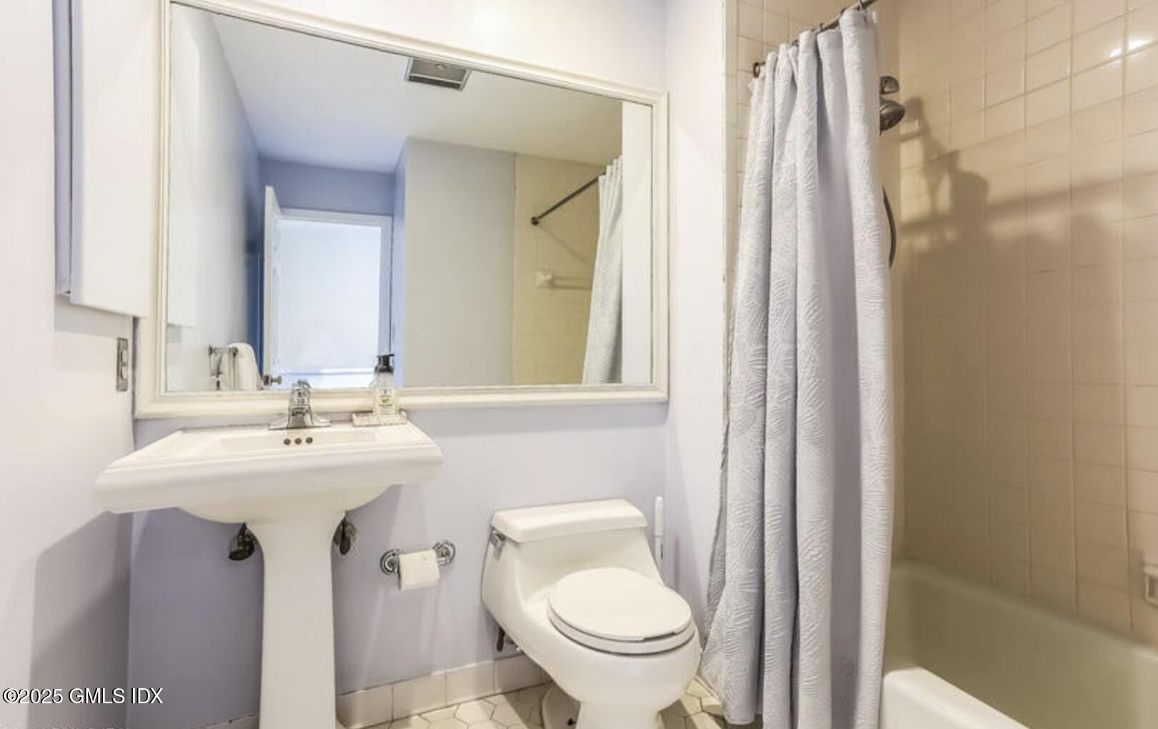 7 River Road, Unit 306 Cos Cob, CT 06807 - Photo 15 of 20 a bathroom with a sink toilet and a mirror