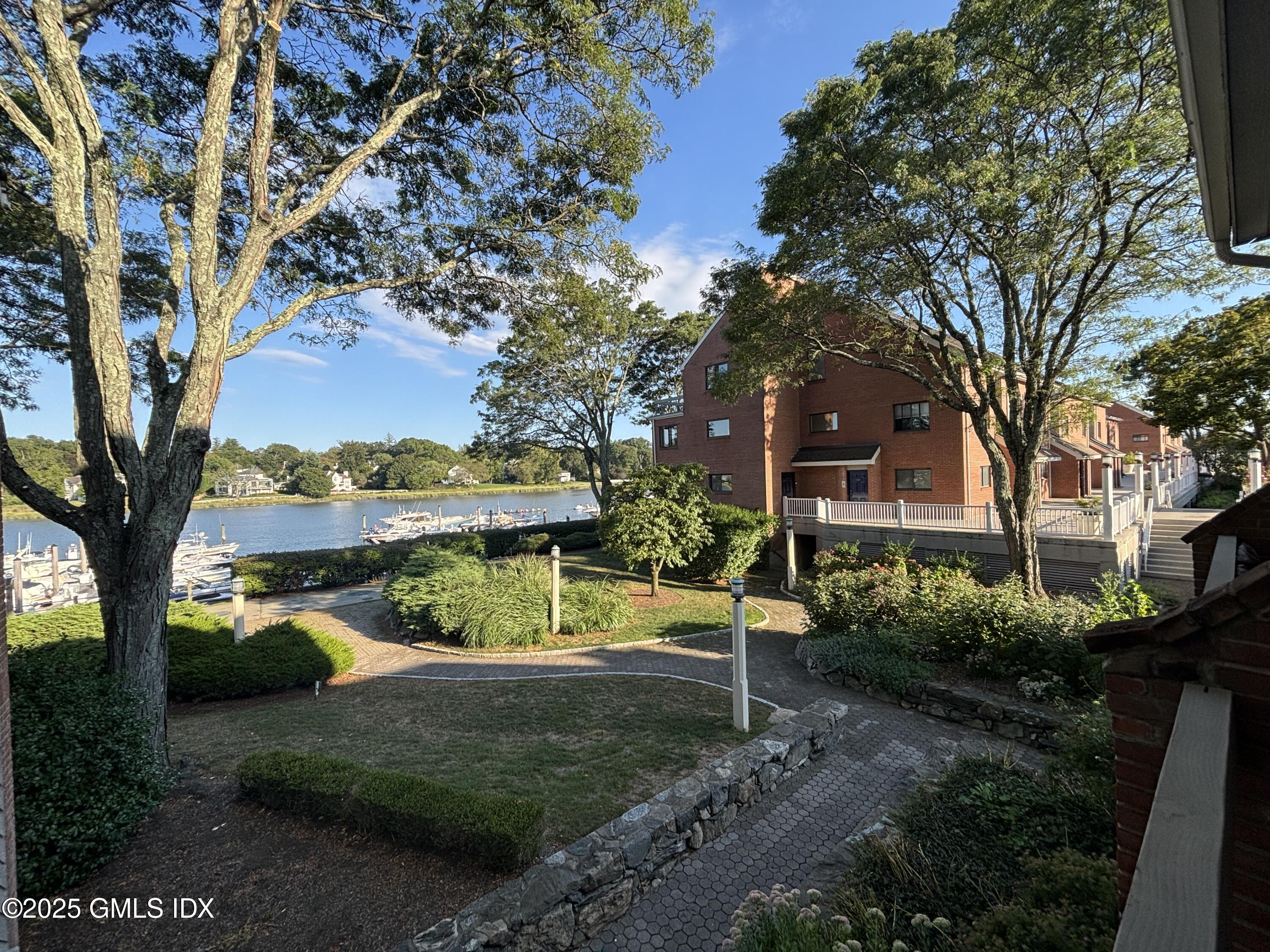 7 River Road, Unit 306 Cos Cob, CT 06807 - Photo 4 of 20 a view of a garden with a tree in front of the house