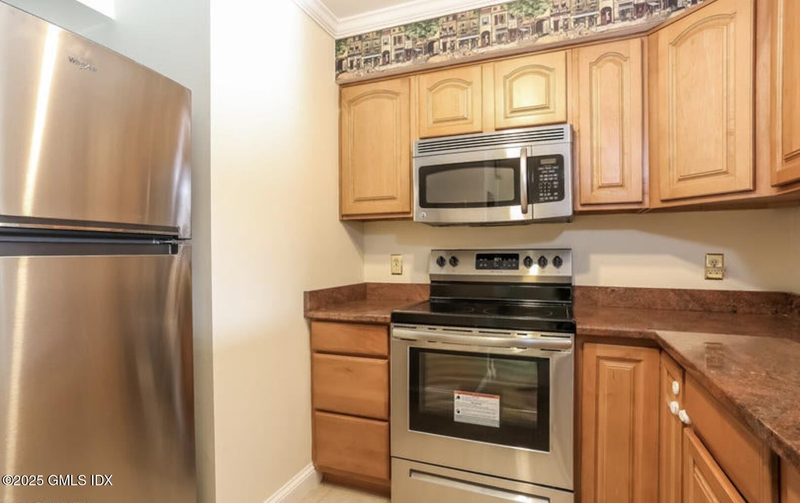 7 River Road, Unit 306 Cos Cob, CT 06807 - Photo 6 of 20 a kitchen with stainless steel appliances granite countertop a refrigerator stove and microwave