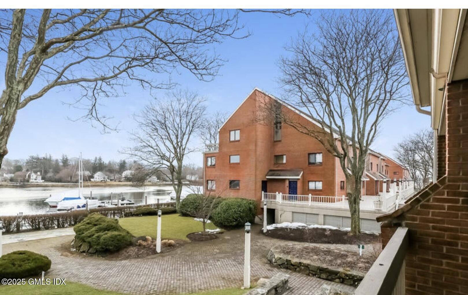 7 River Road, Unit 306 Cos Cob, CT 06807 - Photo 7 of 20 a view of a building with a yard