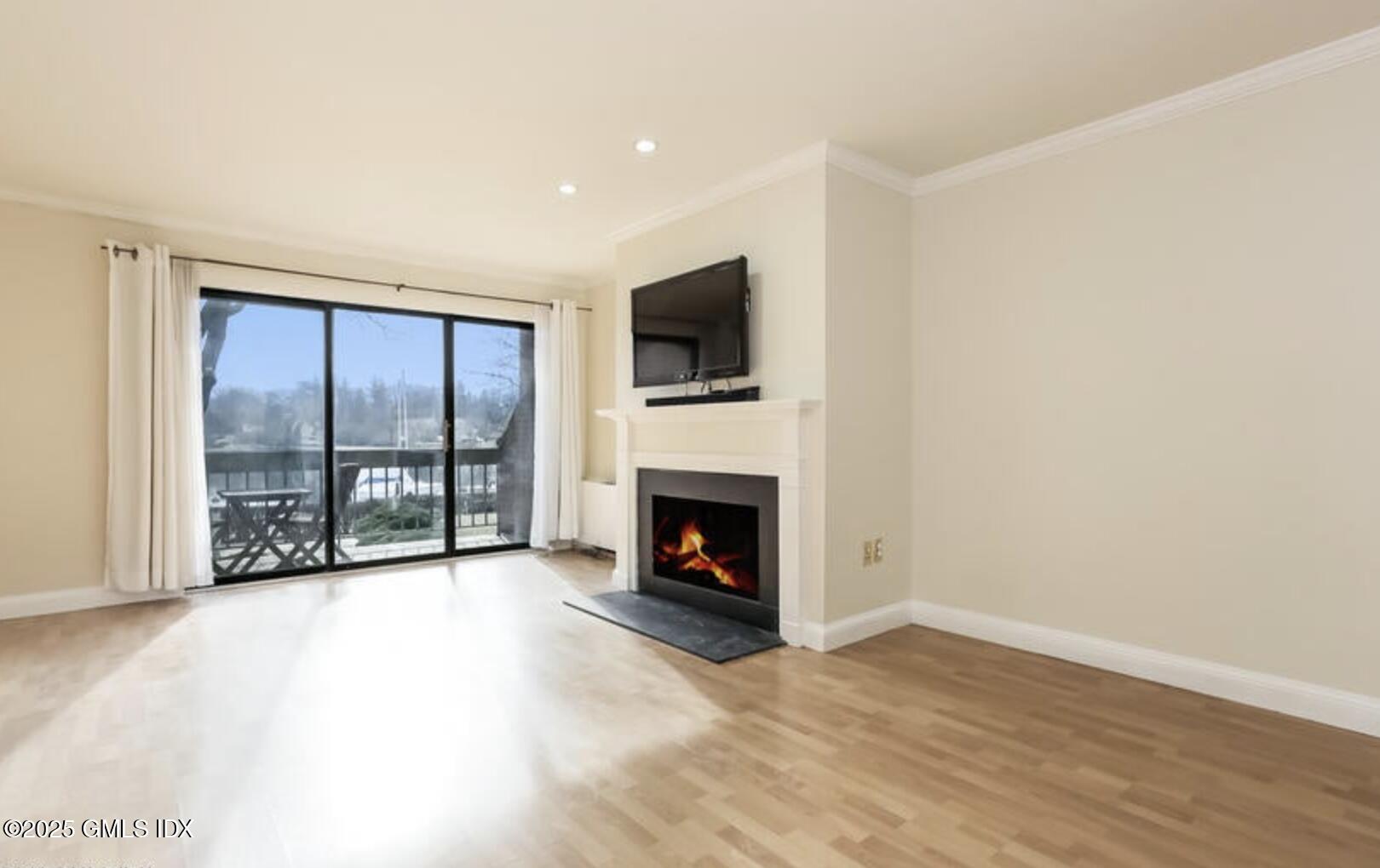 7 River Road, Unit 306 Cos Cob, CT 06807 - Photo 10 of 20 a view of a livingroom with an empty space and a fireplace