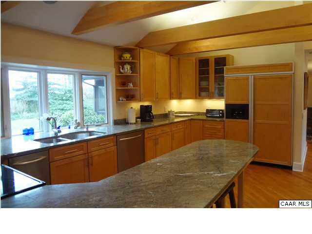1436 Grove Road Charlottesville, VA 22901 - Photo 7 of 25 Stylish kitchen with vaulted ceiling, sky lights, ceiling fan, granite counters & an abundance of handsome maple cabinets.