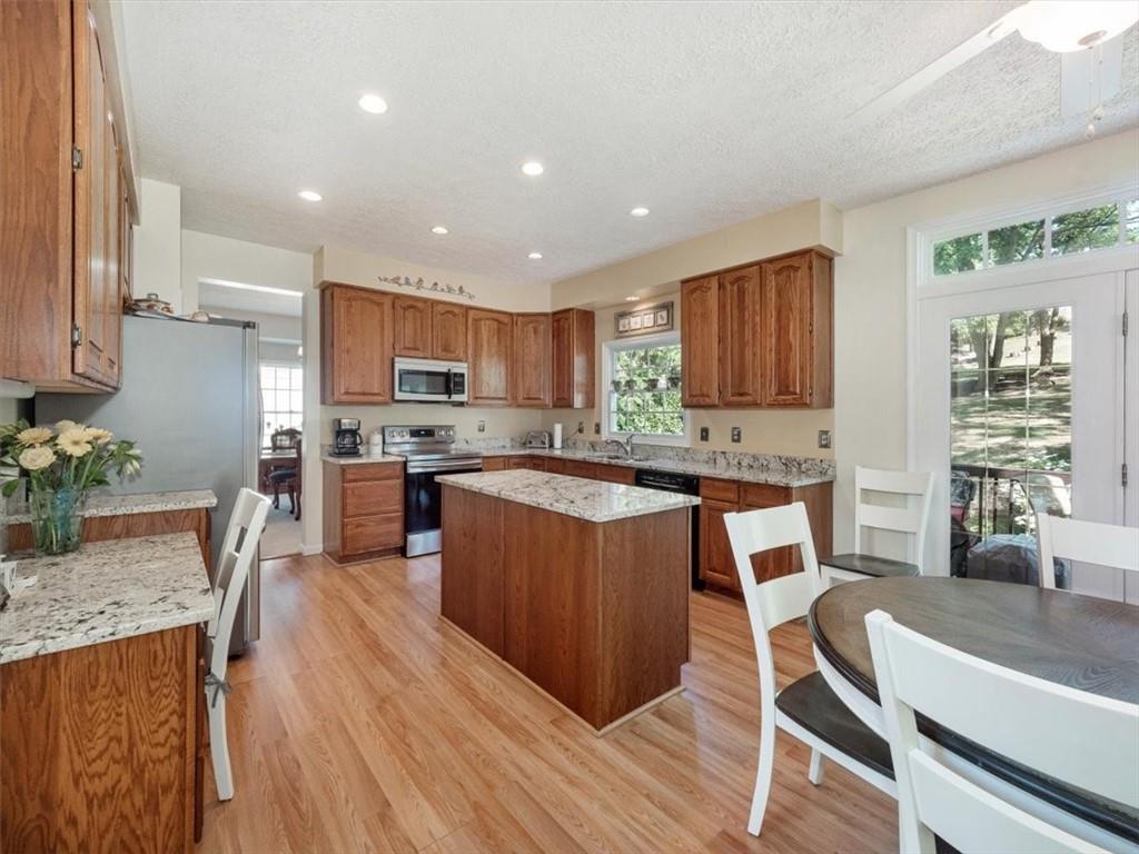 141 Field Club Circle McKees Rocks, PA 15136 - Photo 15 of 25 a kitchen with stainless steel appliances granite countertop wooden cabinets a sink a stove a dining table and chairs