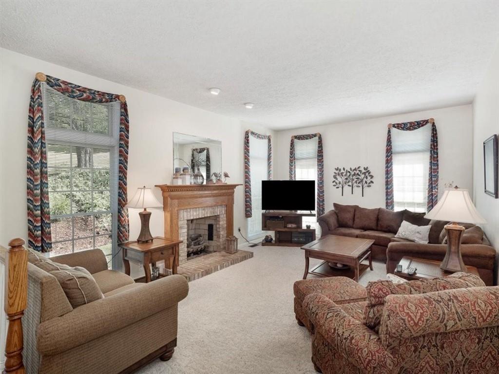 141 Field Club Circle McKees Rocks, PA 15136 - Photo 16 of 25 a living room with furniture a fireplace and a flat screen tv