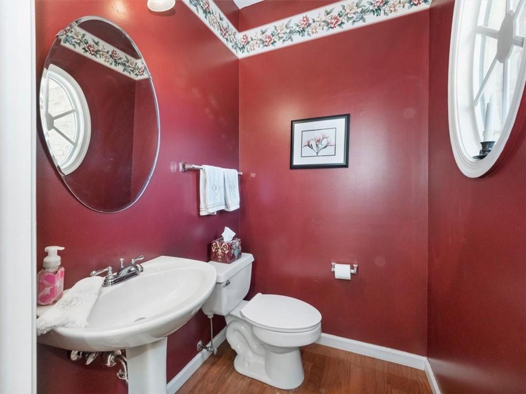 141 Field Club Circle McKees Rocks, PA 15136 - Photo 18 of 25 a bathroom with a toilet a sink and a mirror