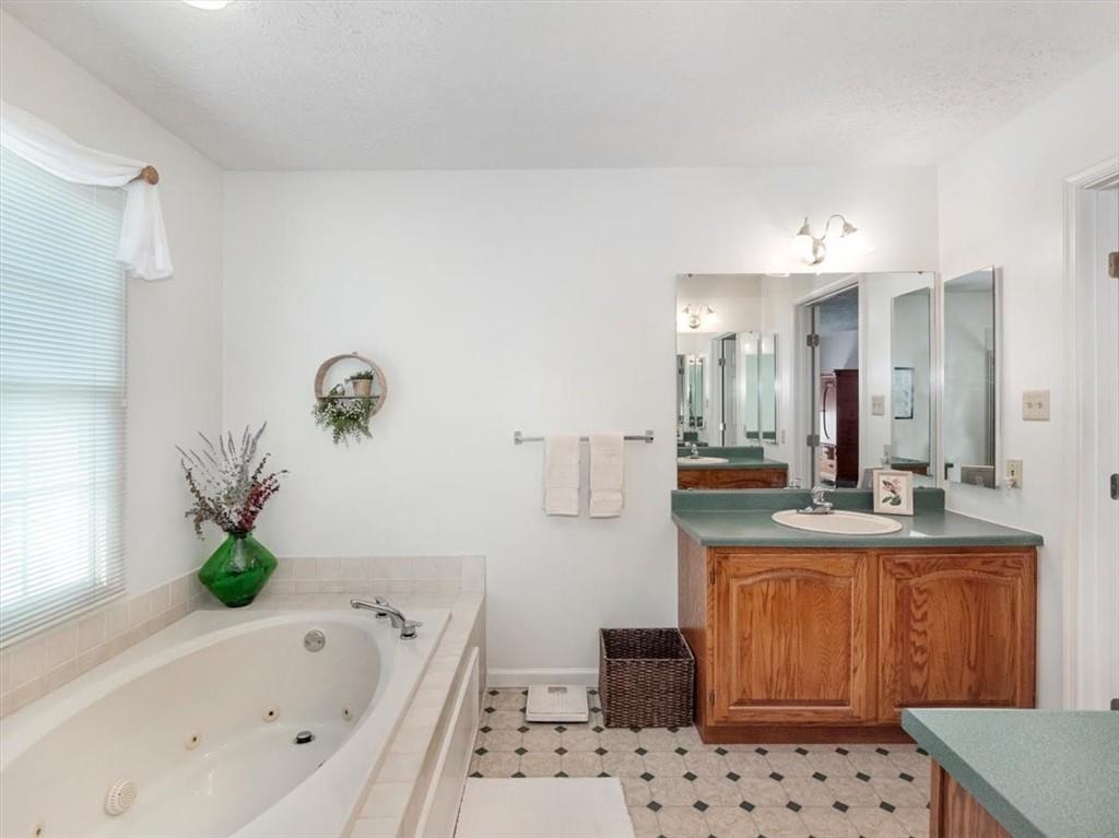 141 Field Club Circle McKees Rocks, PA 15136 - Photo 23 of 25 a bathroom with a bathtub sink and mirror