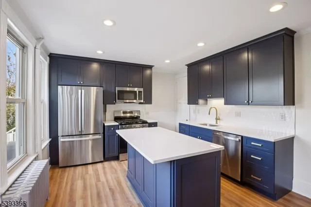 a kitchen with a sink appliances and cabinets