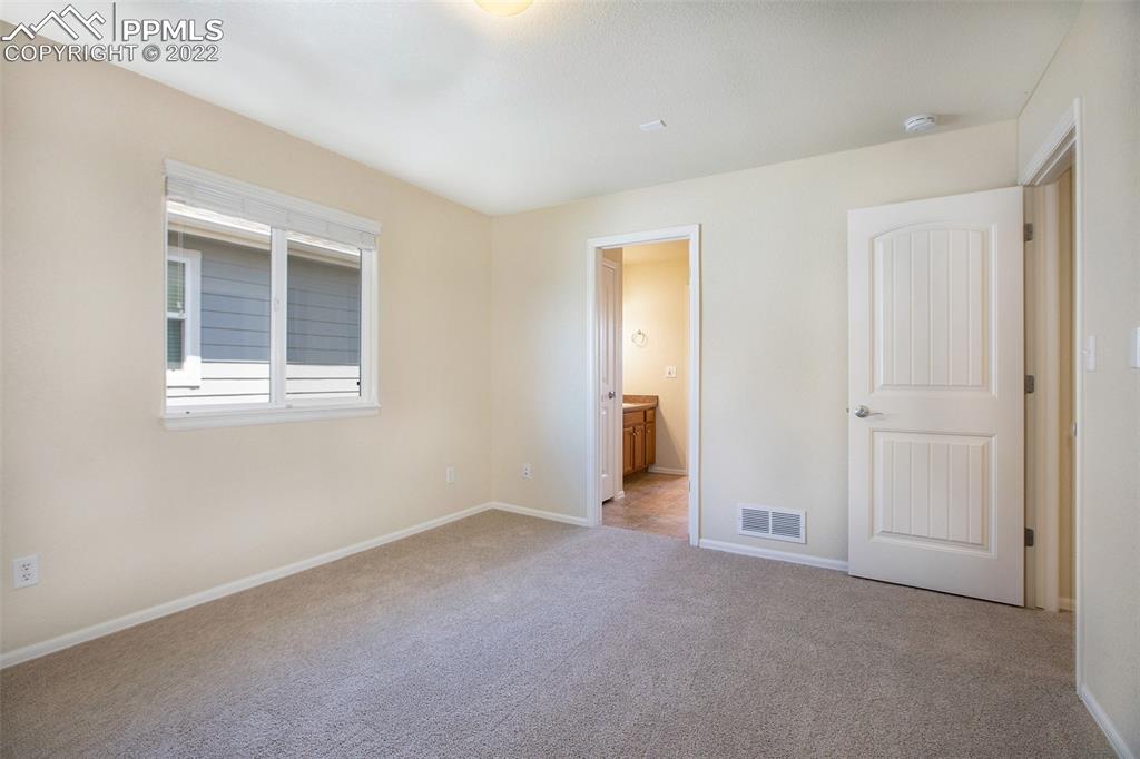 6139 Rocking Chair Lane Colorado Springs, CO 80925 - Photo 12 of 17 a view of an empty room with a window