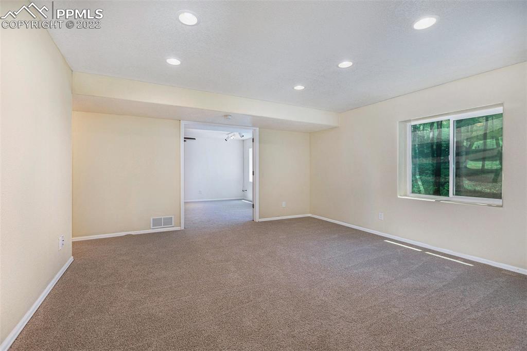 6139 Rocking Chair Lane Colorado Springs, CO 80925 - Photo 15 of 17 an empty room with windows