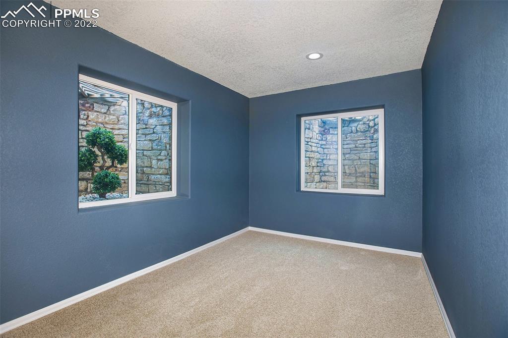6139 Rocking Chair Lane Colorado Springs, CO 80925 - Photo 17 of 17 a view of an empty room with a window