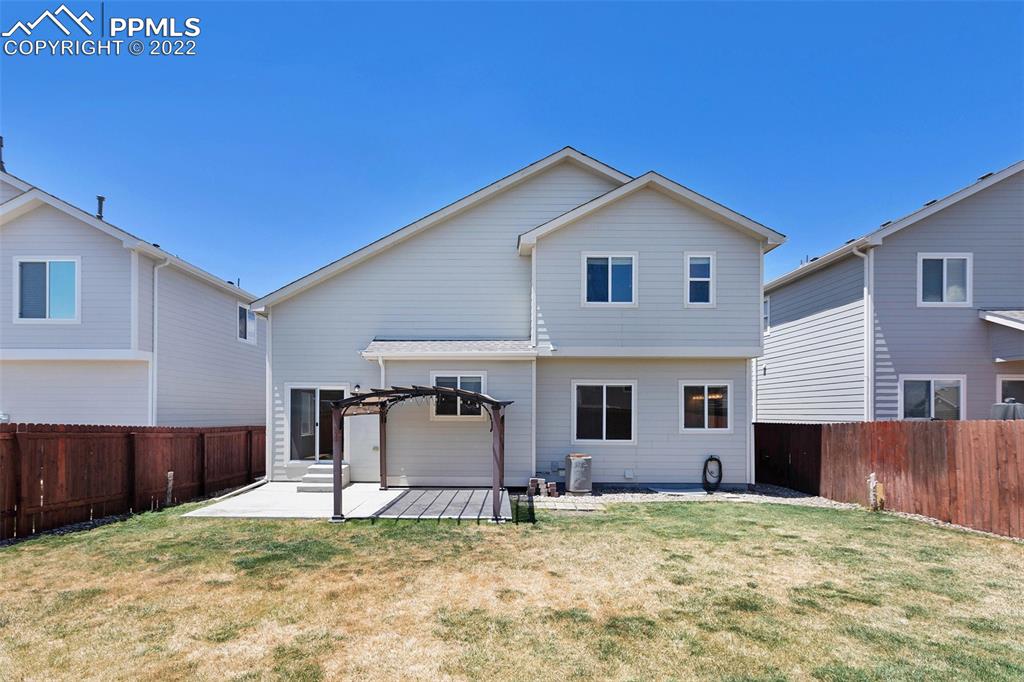 6139 Rocking Chair Lane Colorado Springs, CO 80925 - Photo 5 of 17 a house with trees in the background