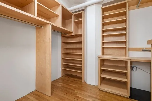 a view of walk in closet with empty racks