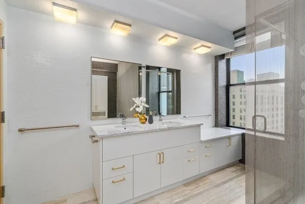a bathroom with a double vanity sink and a mirror