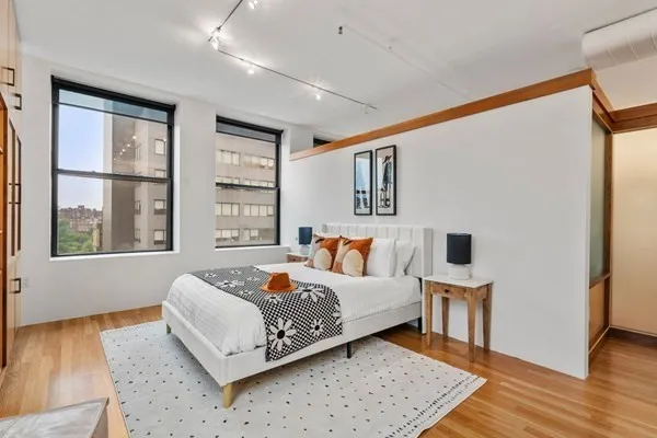 a bed room with a bed and a window