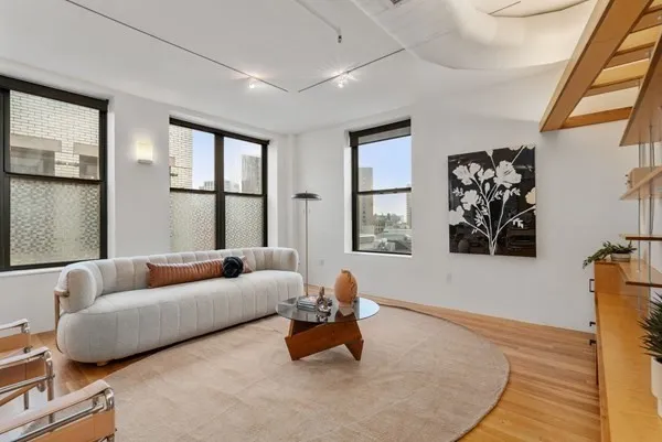 a living room with furniture and a large window