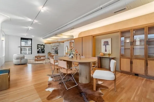 a view of a dining room with furniture window and wooden floor
