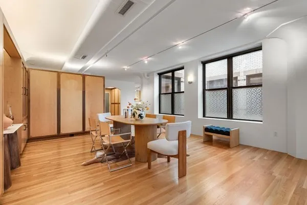 a view of a dining room with furniture window and wooden floor