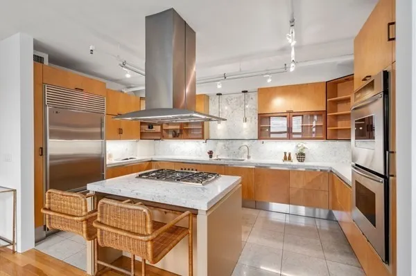 a kitchen with stainless steel appliances granite countertop a sink stove and refrigerator