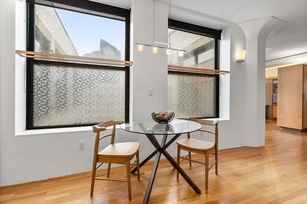 a view of a room with furniture and wooden floor