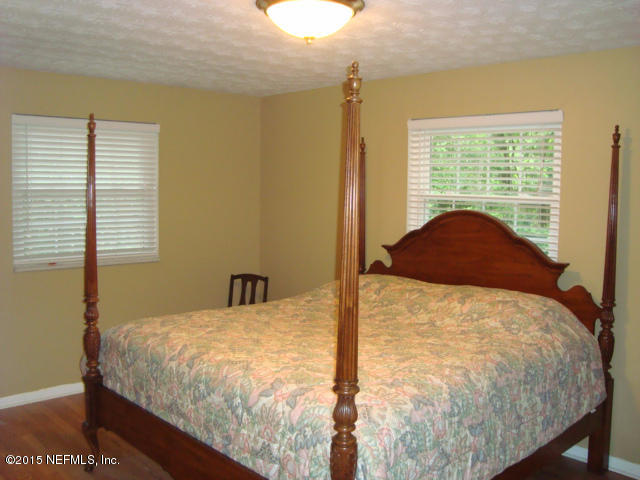 6910 Hermitage Road Jacksonville, FL 32277 - Photo 21 of 42 a bed sitting in a bedroom next to a window