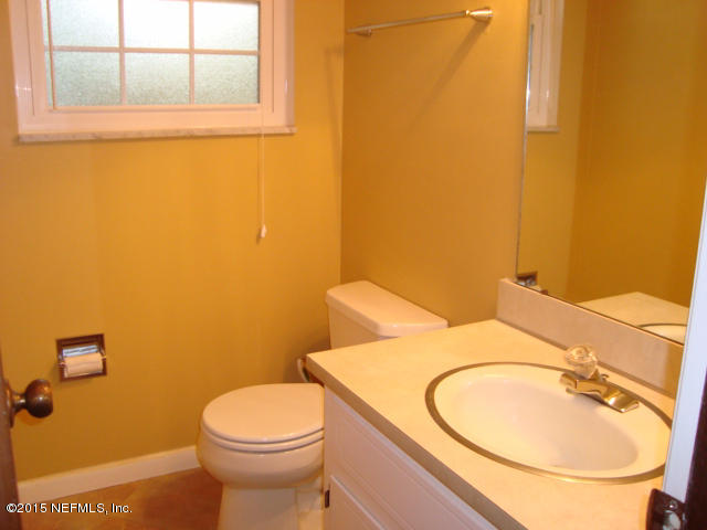 6910 Hermitage Road Jacksonville, FL 32277 - Photo 32 of 42 a bathroom with a sink a toilet and a mirror