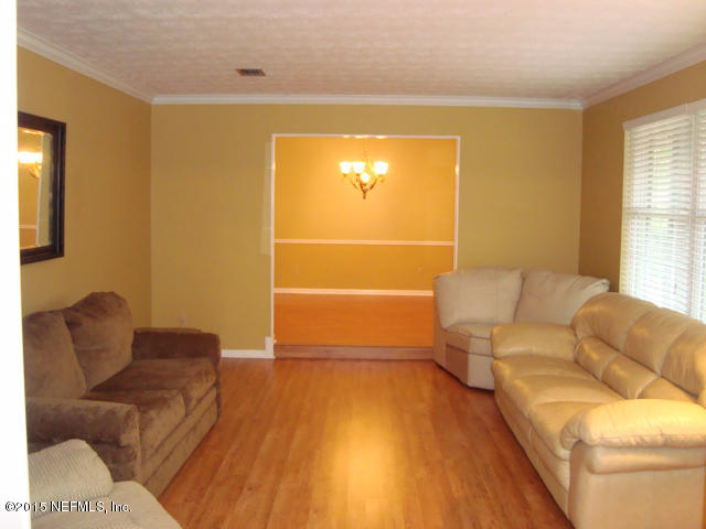 6910 Hermitage Road Jacksonville, FL 32277 - Photo 5 of 42 a living room with furniture and a flat screen tv