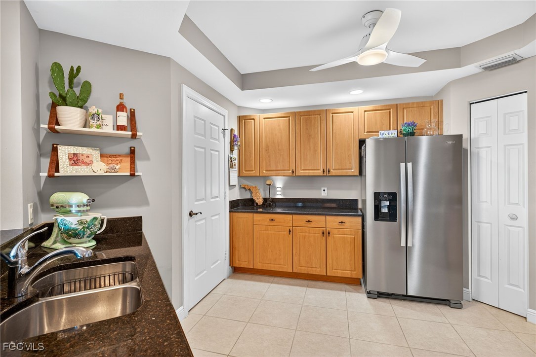 2743 First Street, Unit 701 Fort Myers, FL 33916 - Photo 12 of 31 a kitchen with stainless steel appliances granite countertop a refrigerator and a sink