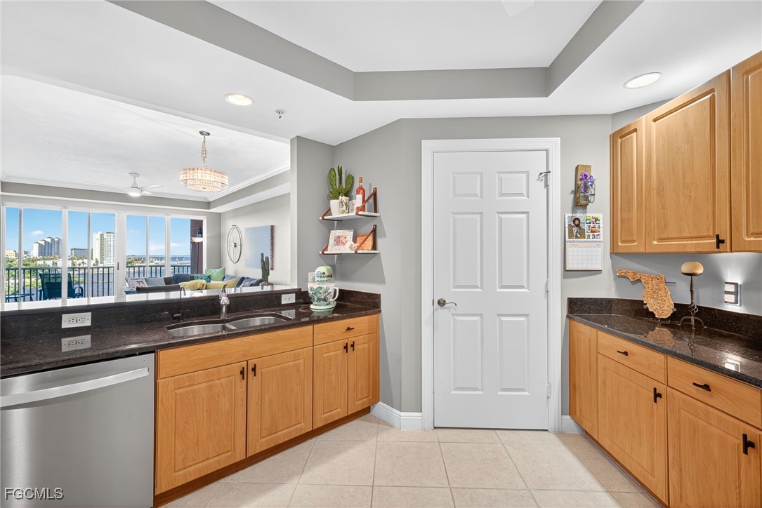 2743 First Street, Unit 701 Fort Myers, FL 33916 - Photo 13 of 31 a kitchen with stainless steel appliances granite countertop a sink and cabinets