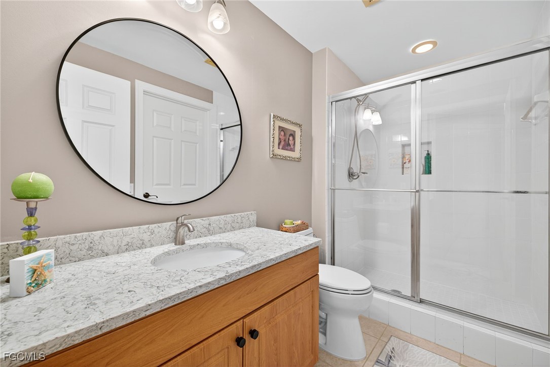 2743 First Street, Unit 701 Fort Myers, FL 33916 - Photo 24 of 31 a bathroom with a granite countertop sink mirror toilet and shower