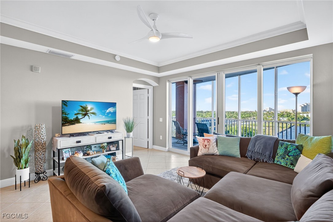 2743 First Street, Unit 701 Fort Myers, FL 33916 - Photo 5 of 31 a living room with furniture a large window and a flat screen tv