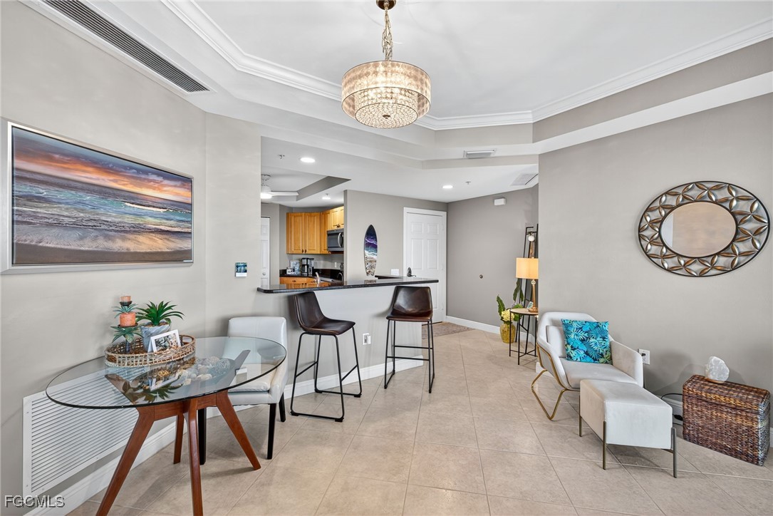 2743 First Street, Unit 701 Fort Myers, FL 33916 - Photo 7 of 31 a view of a dining room with furniture and chandelier
