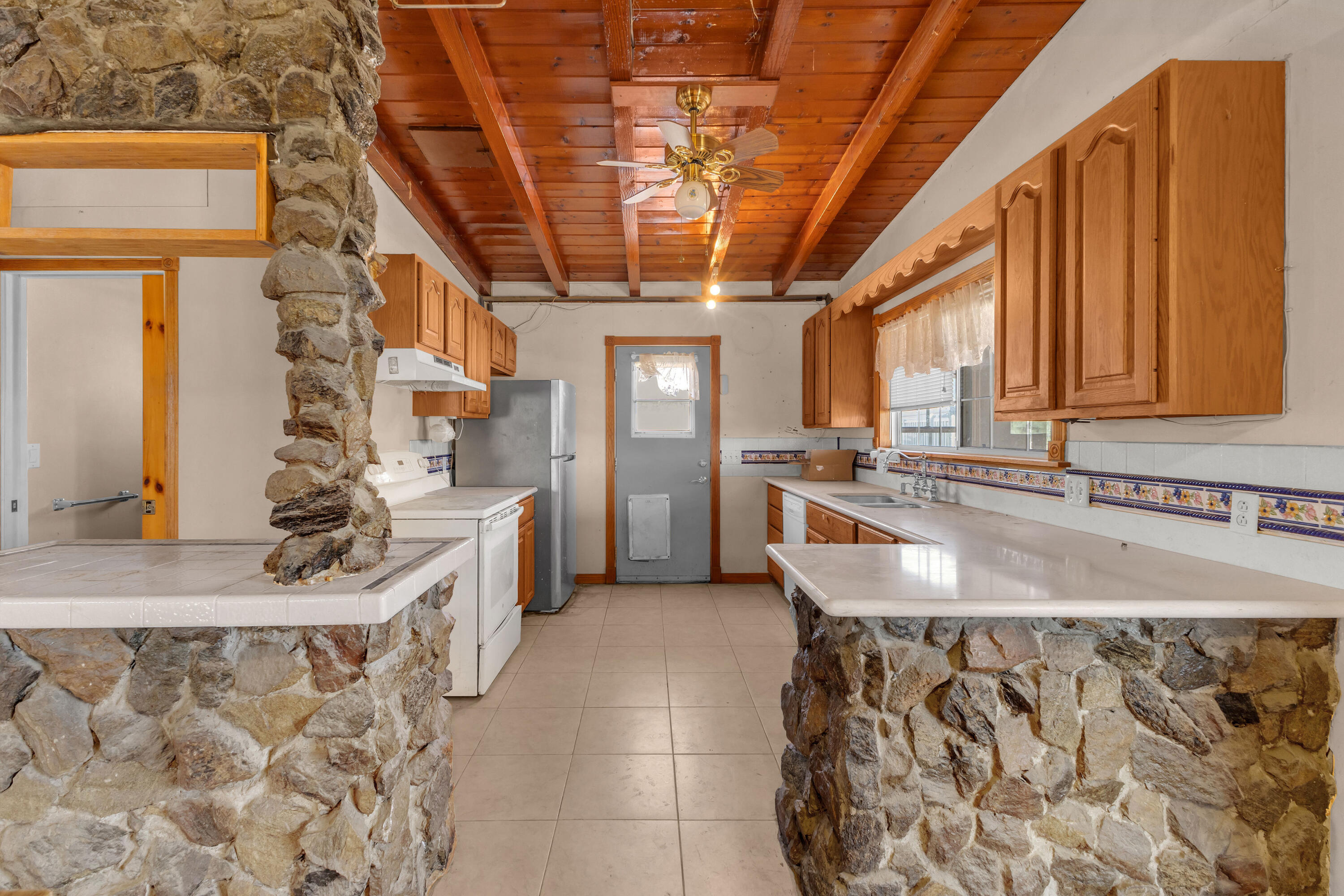 81975 Dillon Road Desert Hot Springs, CA 92241 - Photo 3 of 51 a large white kitchen with a large window