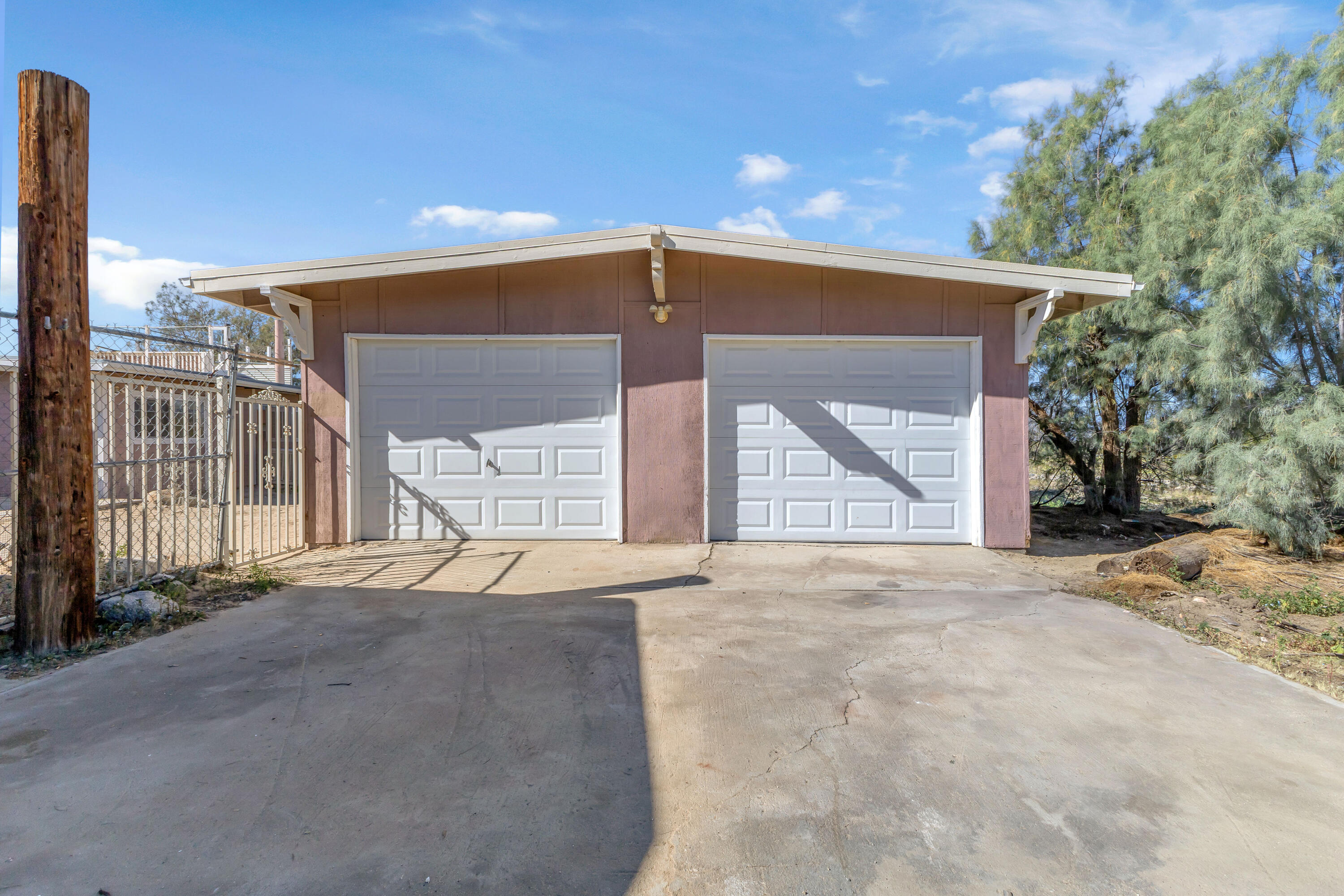 81975 Dillon Road Desert Hot Springs, CA 92241 - Photo 35 of 51 a front view of a house with a yard and garage